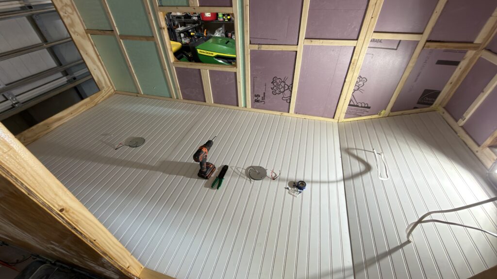 DIY camper ceiling paneling installation in a homemade camper